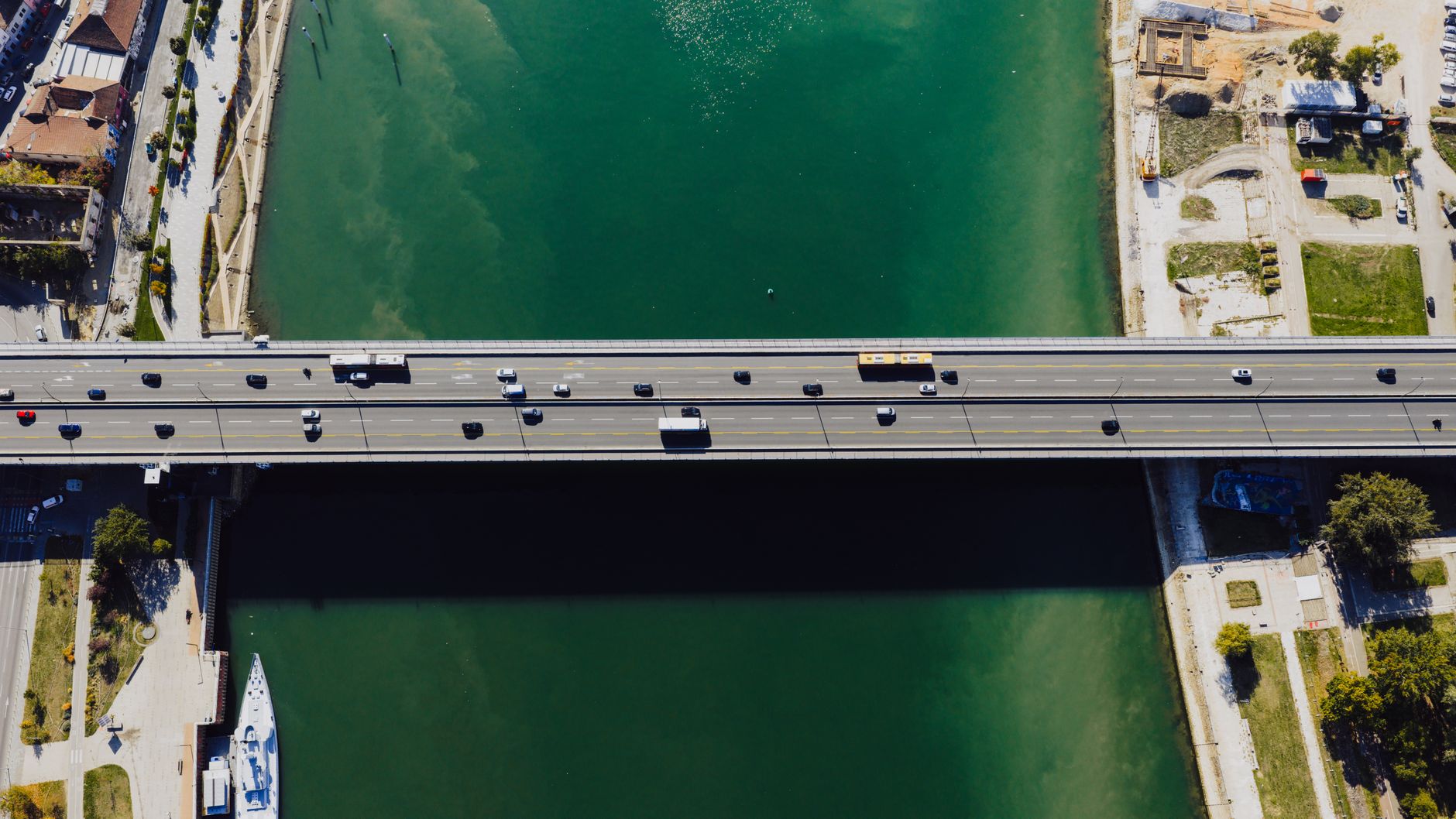 Drone shot capturing a busy bridge over a river in Belgrade, Serbia on a sunny day.