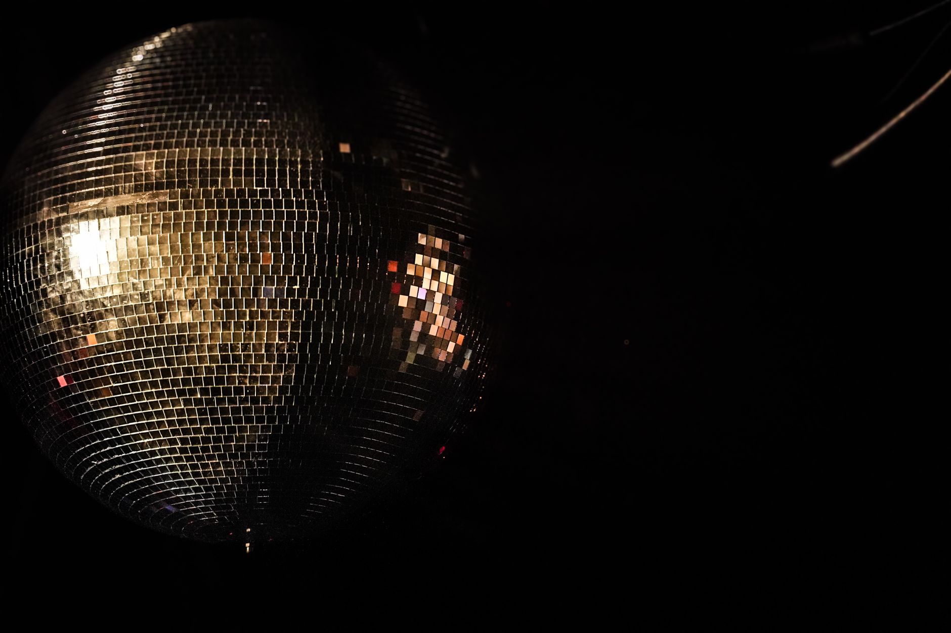 A shining disco ball reflecting light in a dark setting, capturing the essence of nightlife in Montréal.