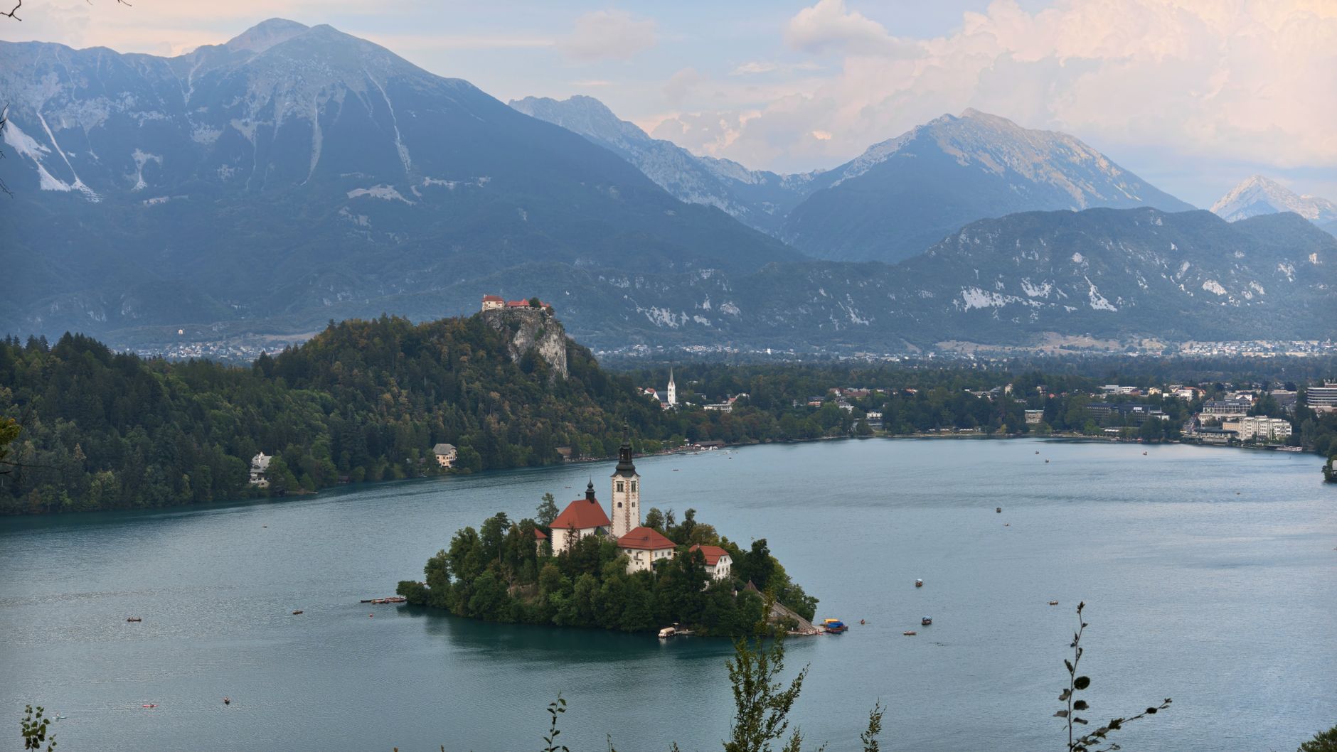A breathtaking view of Lake Bled and the iconic Church on the Island with Alps in the background.